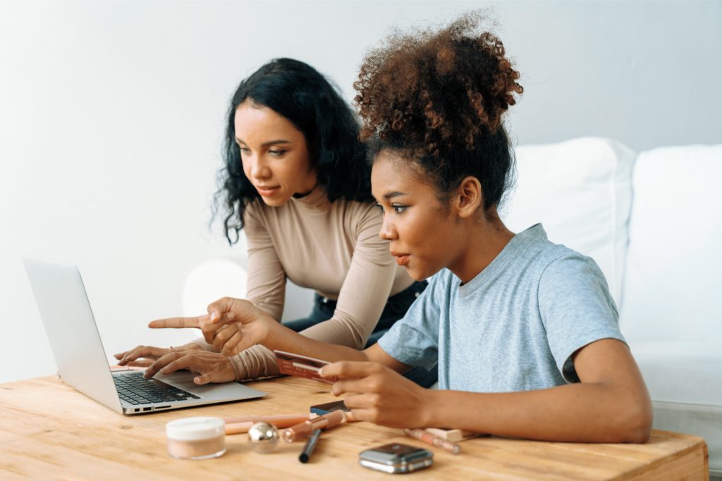 Young happy woman buy product by online shopping home while ordering items from internet with credit card online payment system protected by crucial cyber security from online store platform